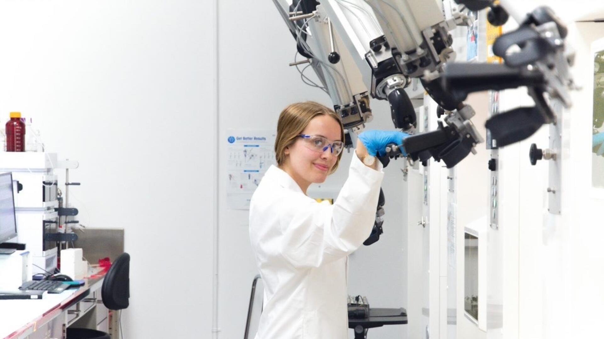 Brooke McNeil using a large microscope.