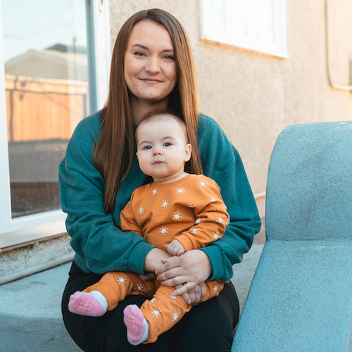Sara holds her baby.