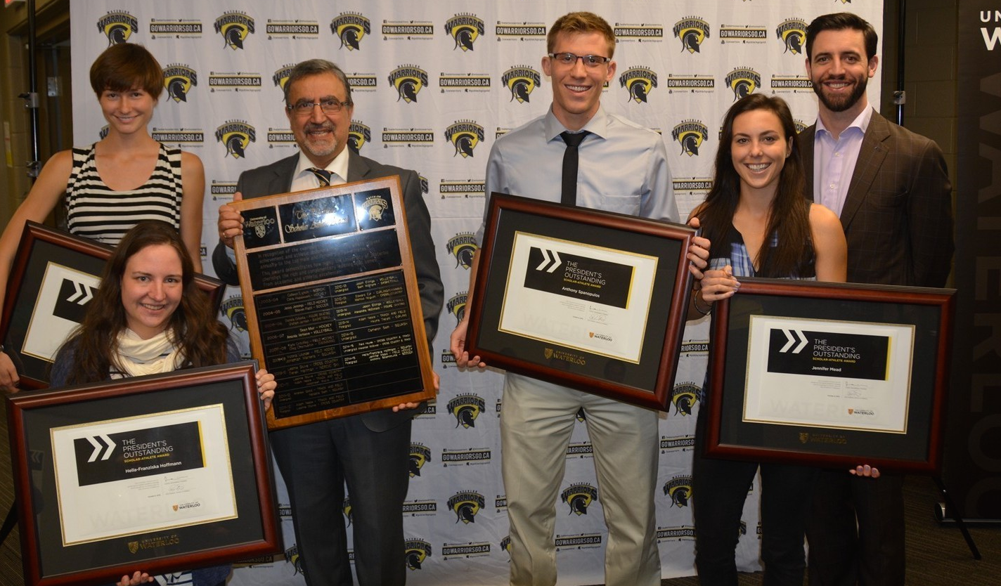 Feridun Hamdullahpur and student athletes pose with honour roll certificates.