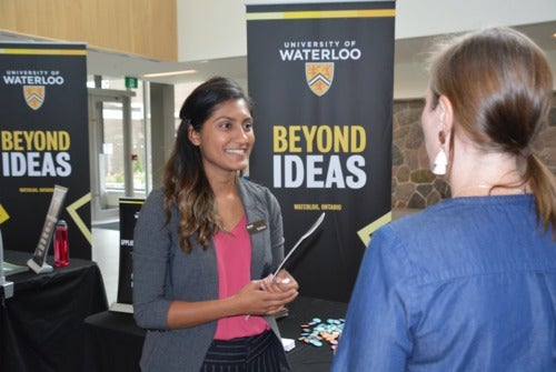 A volunteer liaison assists a Grade 10 Family Night patron.