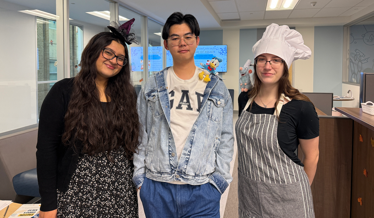 Three co-op students wearing Halloween costumes.