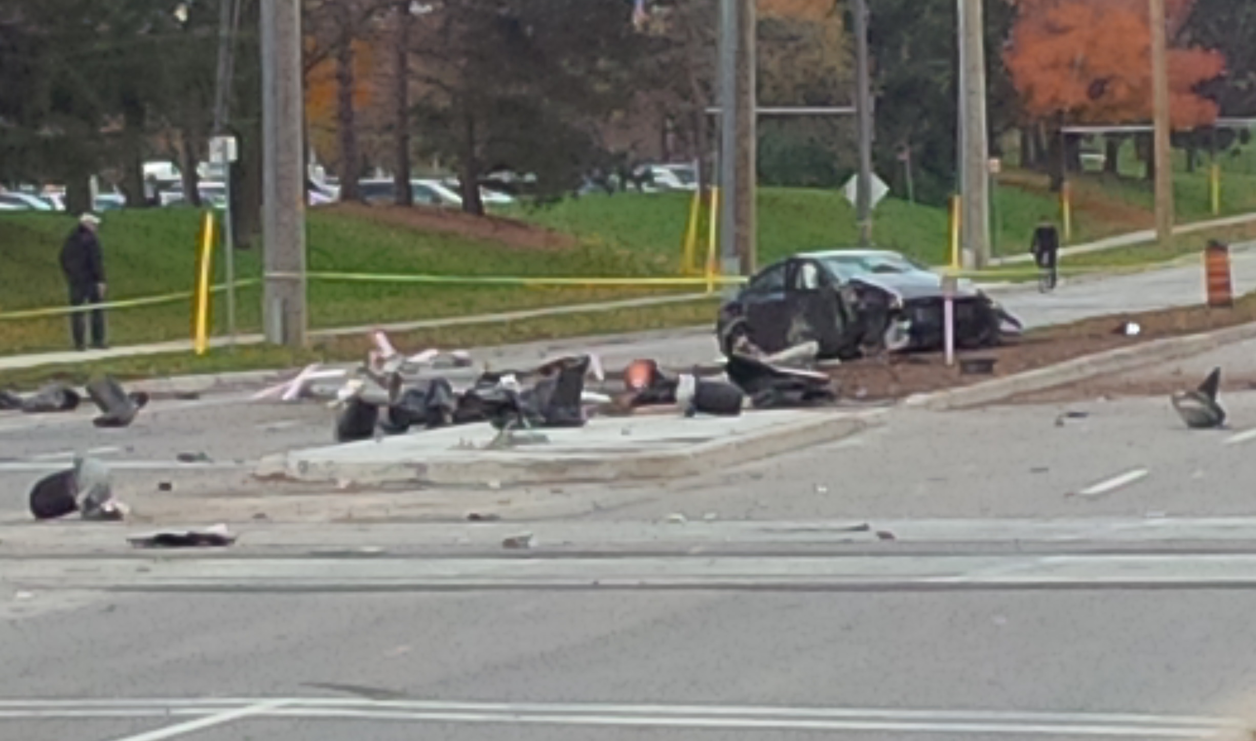 A crashed car in the middle of Columbia Street surrounded by debris.