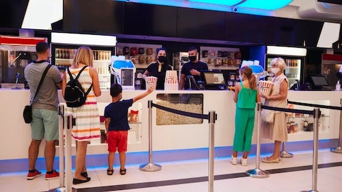 Customers at a movie theatre concession stand.