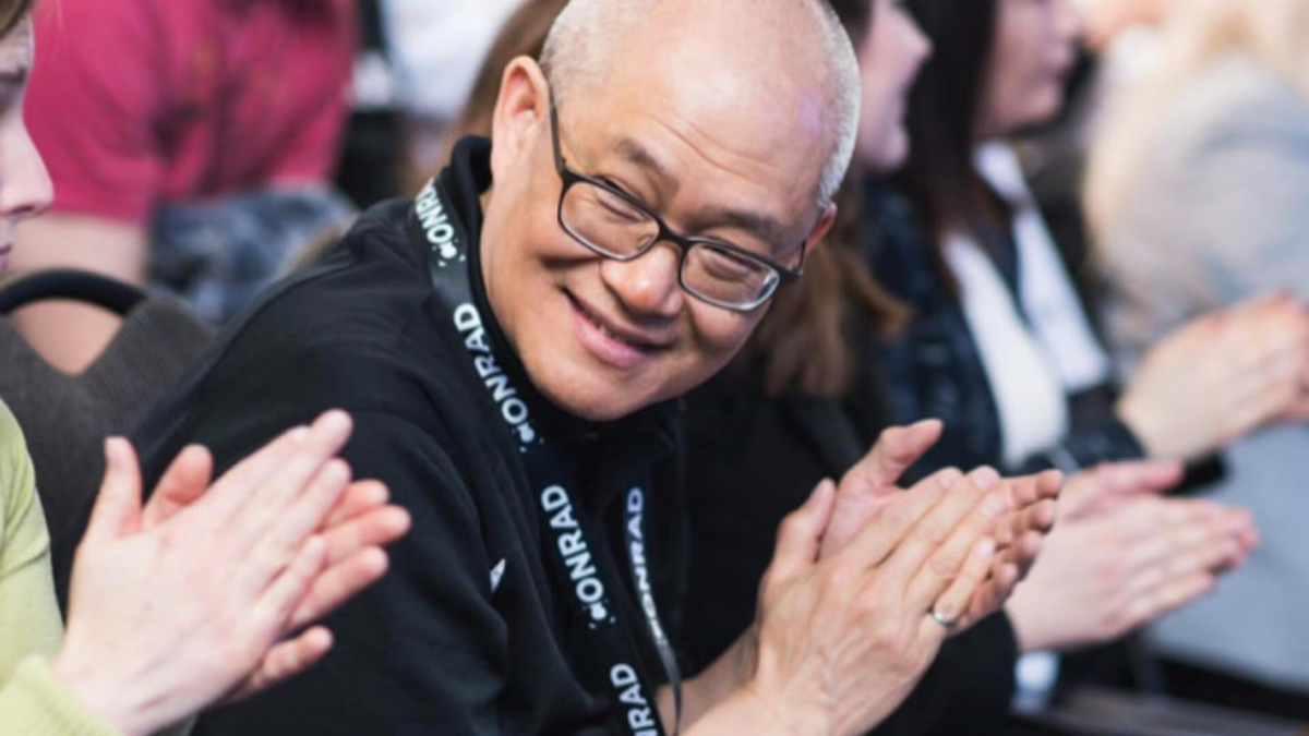 Professor Wayne Chang claps during a pitch competition.