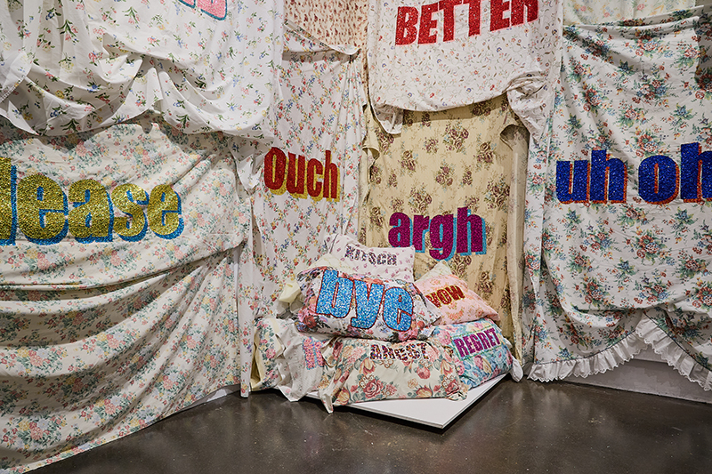 Quilts and bedsheets with slogans like "ouch," "uh-oh" and "better" on them.