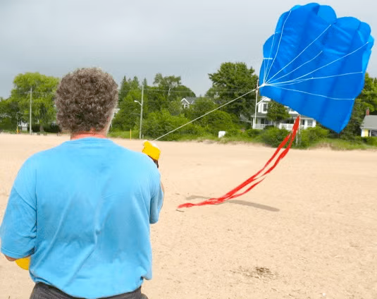 Joe Bevan prepares a parachute-style kite to take to the air.