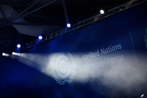 A stage setup with the words United Nations Climate Change on a wall banner.