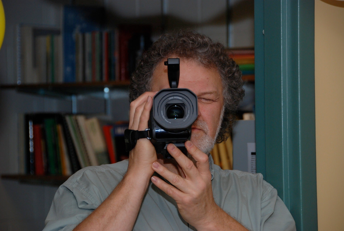 Joe Bevan holds up a camera to take a picture.