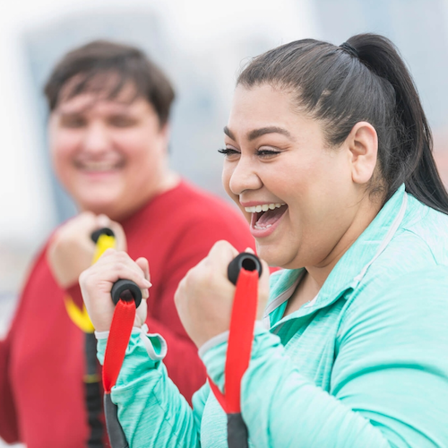 A woman works out with exercise bands.