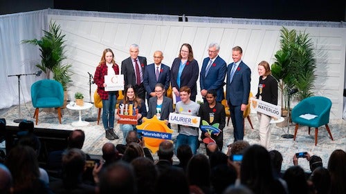 President Vivek Goel, representatives from RBC, and students from local post-secondary institutions together on stage.