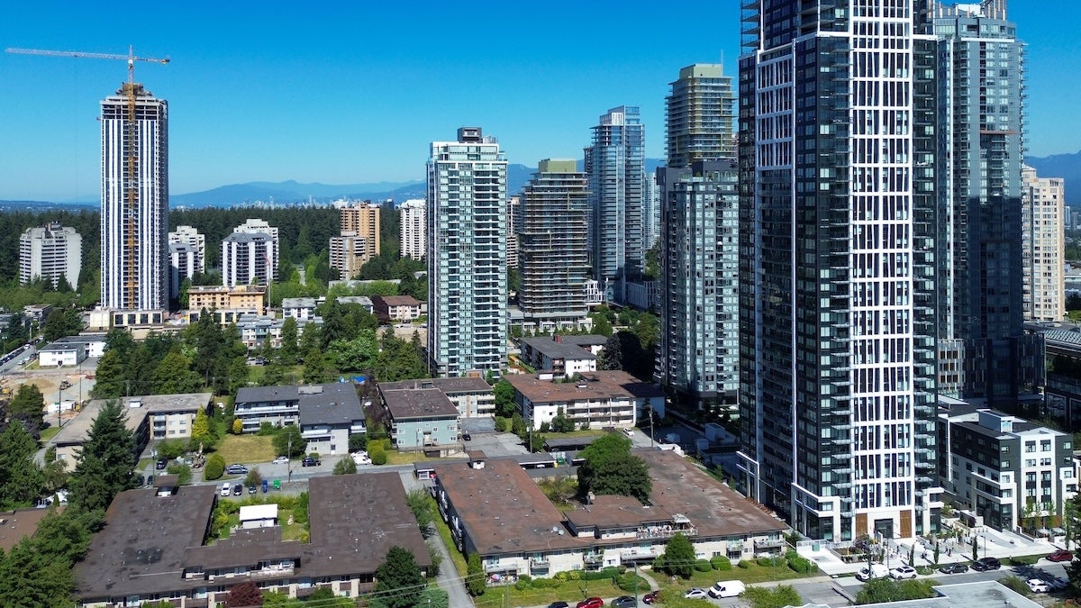 The skyline of downtown Burnaby BC with mountains in the background.