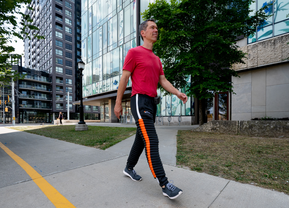 Caleb Horst walks while wearing the python pant compression sleeve on his leg.
