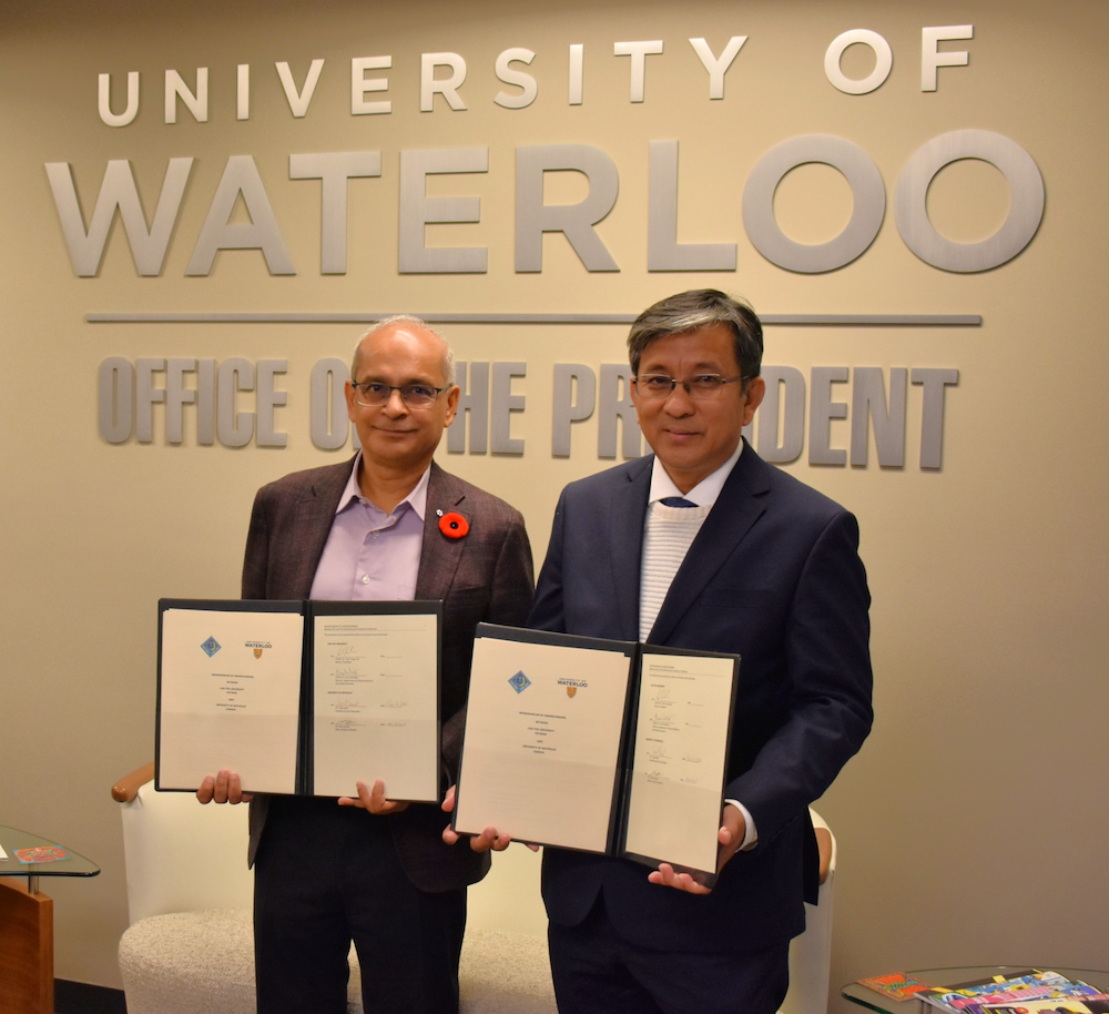 President Vivek Goel and Tran Trung Tinh, Rector of Can Tho University, stand with signed agreements.