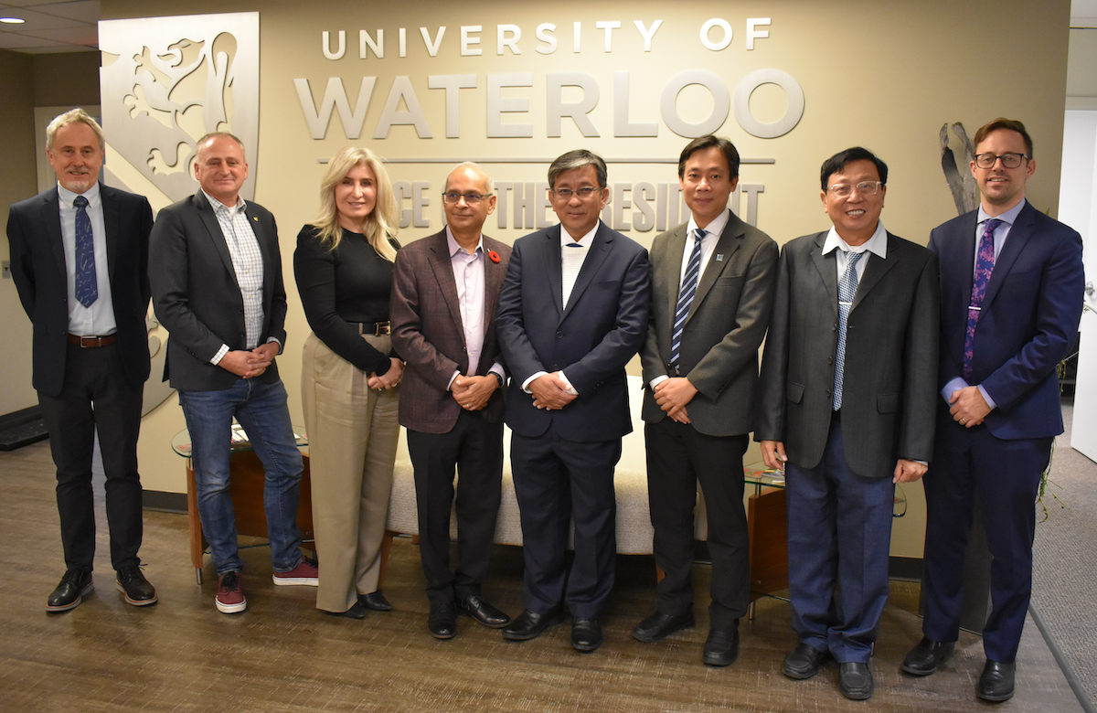 The delegates from Waterloo and Vietnam stand together.