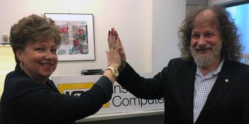 Vera Korody and Vic DiCiccio exchange a high-five.