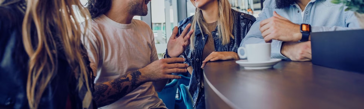 People converse at a coffee bar.