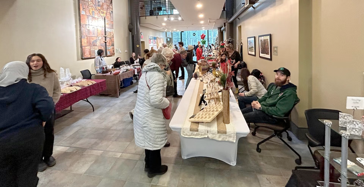 Shoppers browse tables at the Make a Difference Holiday Market.