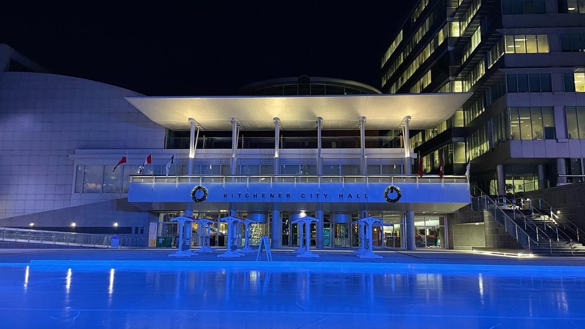 City Hall in Kitchener lit up in blue lights.