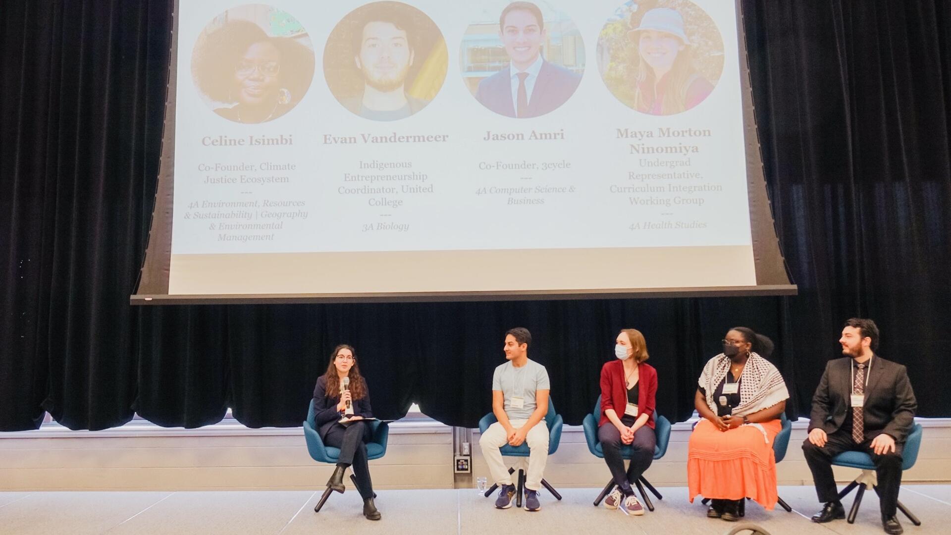 A panel of speakers on stage at the Eco Summit.