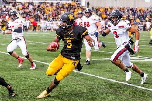 Tre Ford carries the ball downfield in a game against Carleton.