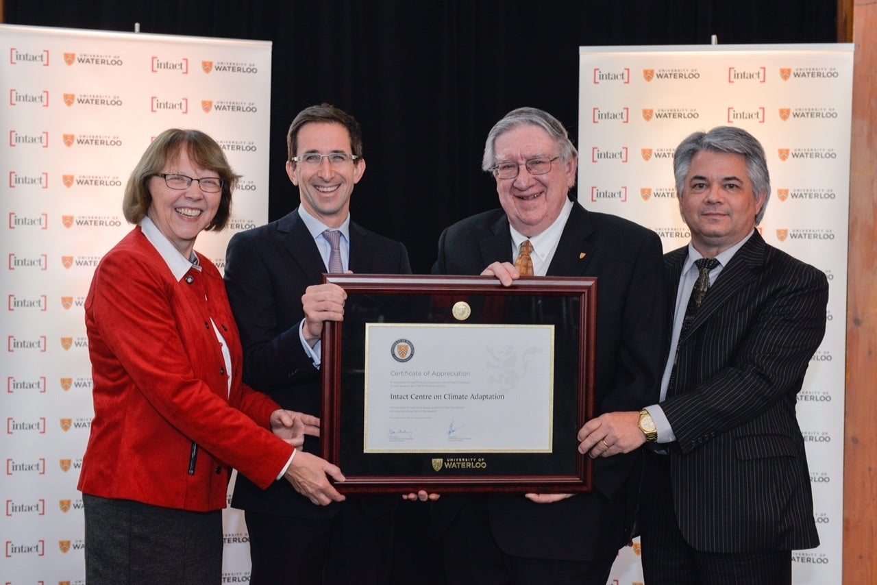 Dean of Environment Jean Andrey, Intact Financial Corporation CEO Charles Brindamour, Vice-President, University Research George Dixon, and Blair Feltmate pose with a plaque at the announcement.