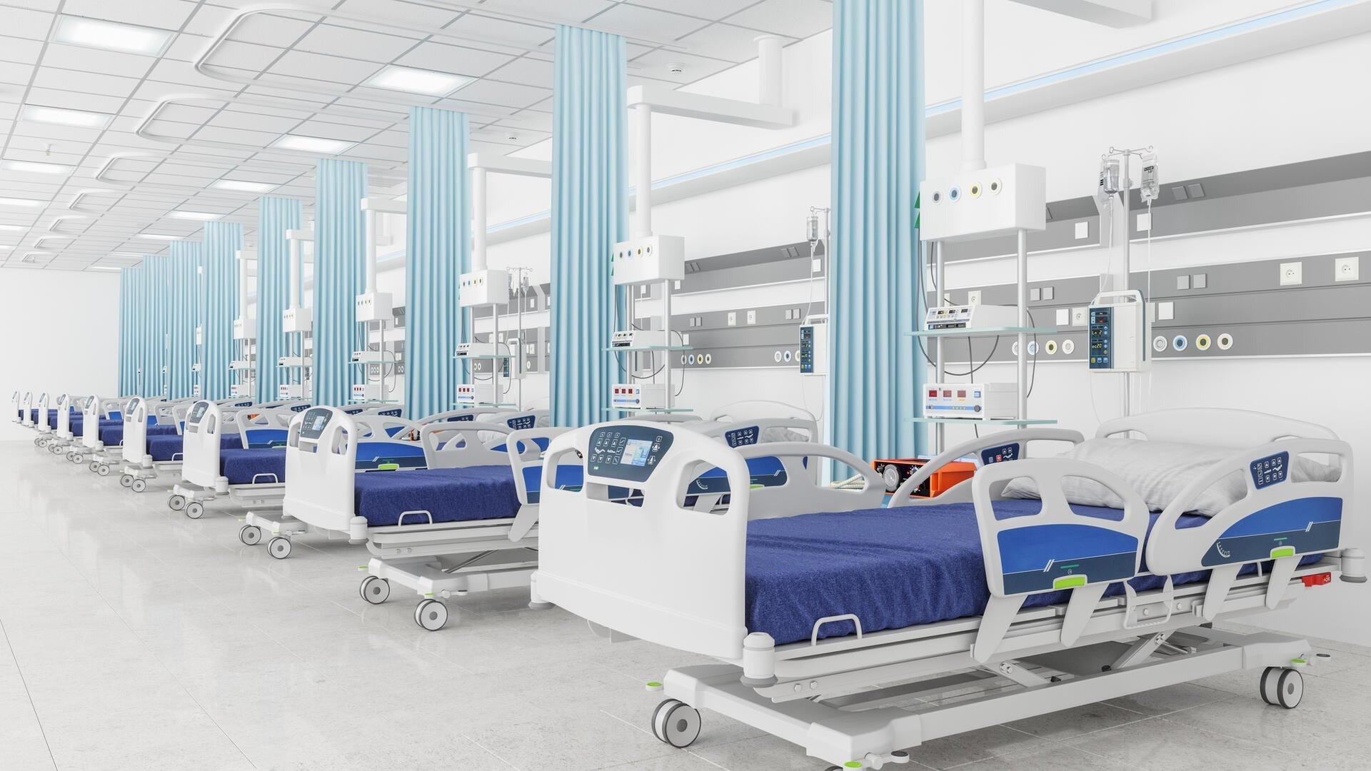 A stock image of an empty ICU unit showing medical beds.