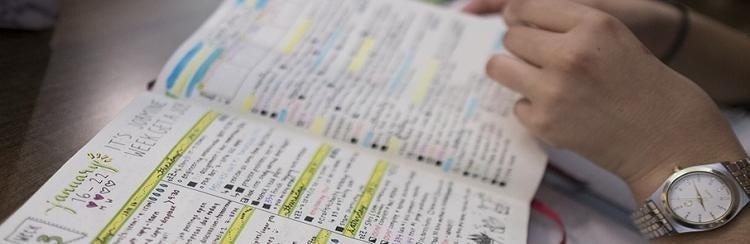 A student pores over study notes.