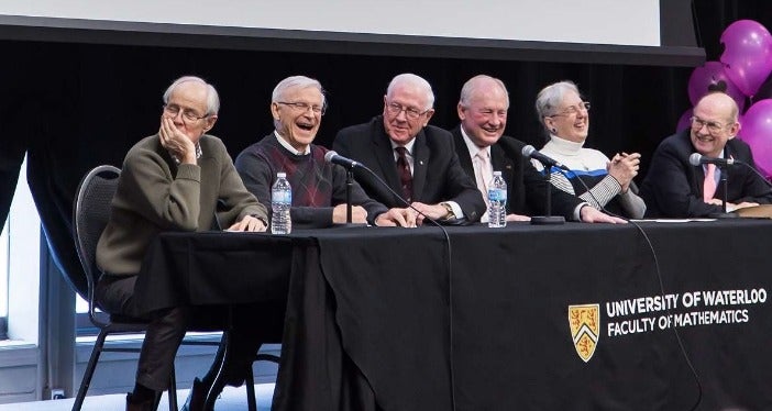 Participants in a Mathematics 50th anniversary panel laugh together.