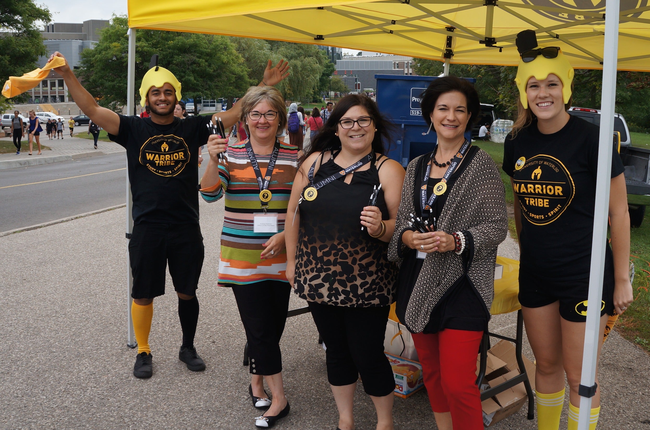 Andrea Kelman, Jennifer Knight, and Lori Gamble pose with members of the Warrior Tribe at Orientation 2016.