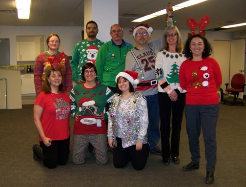 Members of Plant Operations show off their ugly Christmas sweaters.