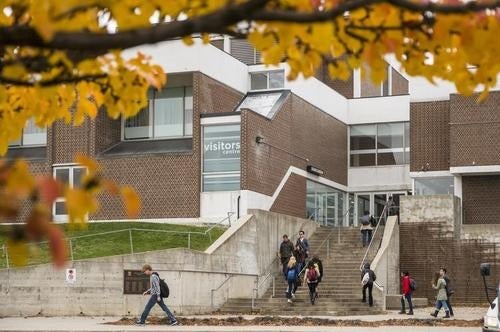students walking down steps from a building