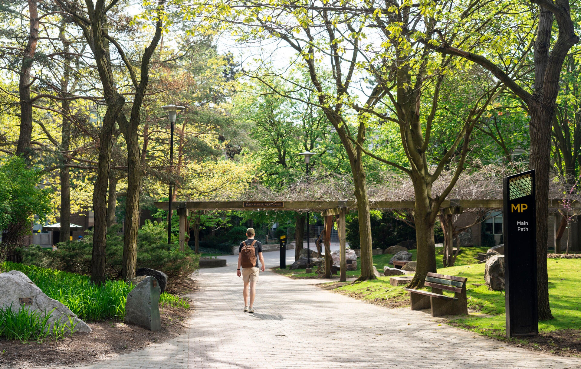 student walking through rock garden