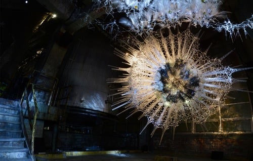 hanging art installation made up of lights that look like a sprawling network