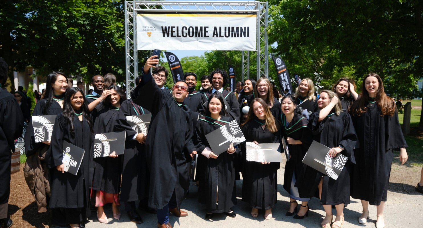 Convocation: Graduates pose together for a selfie in robes and gowns with degrees in hand
