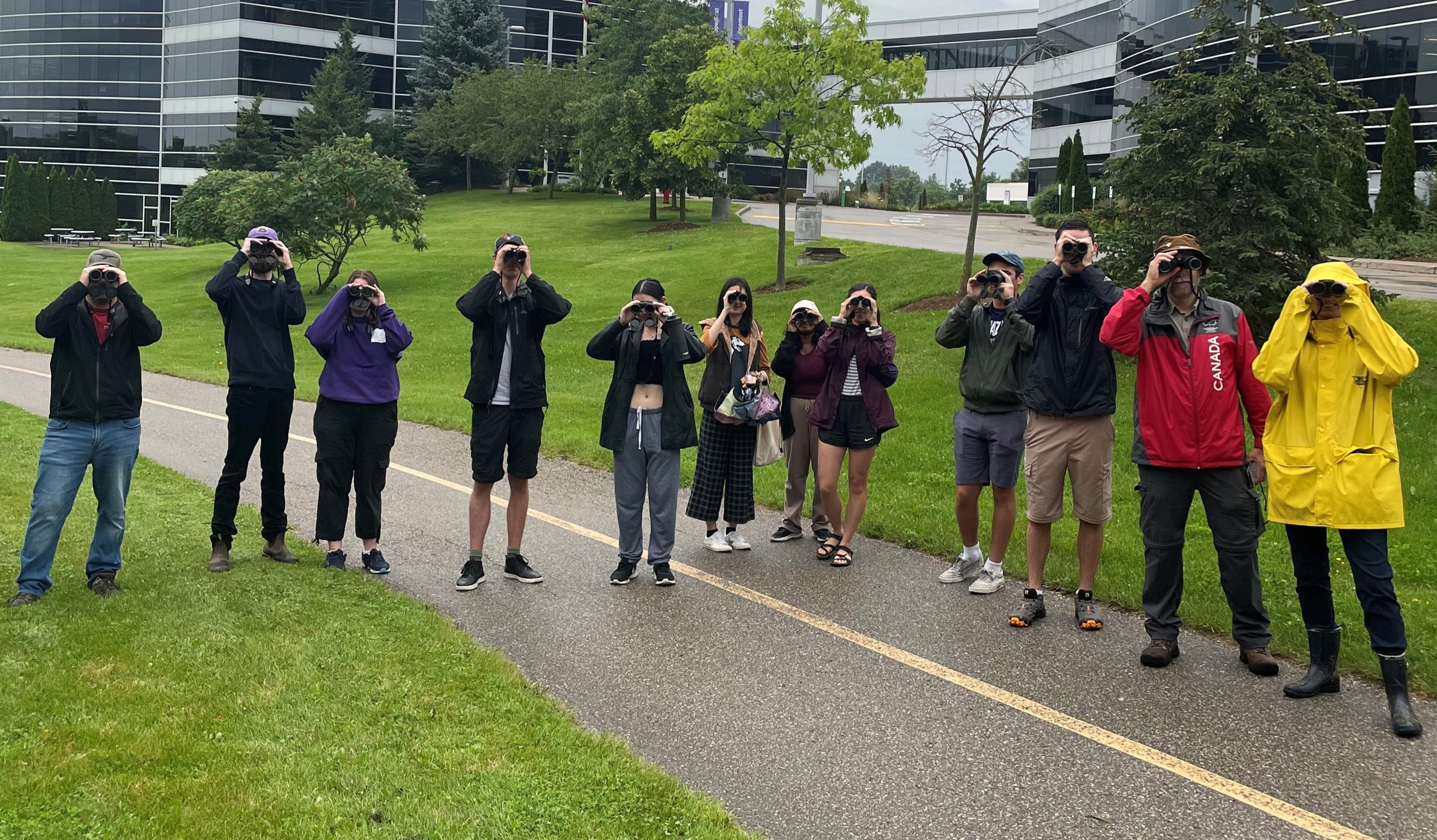 Group of students outside looking through binoculars