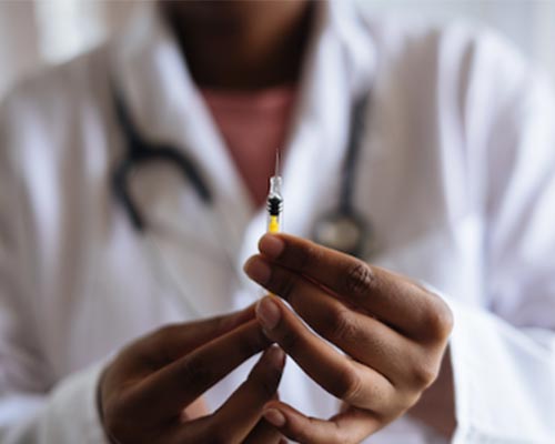 Technician adjusts syringe