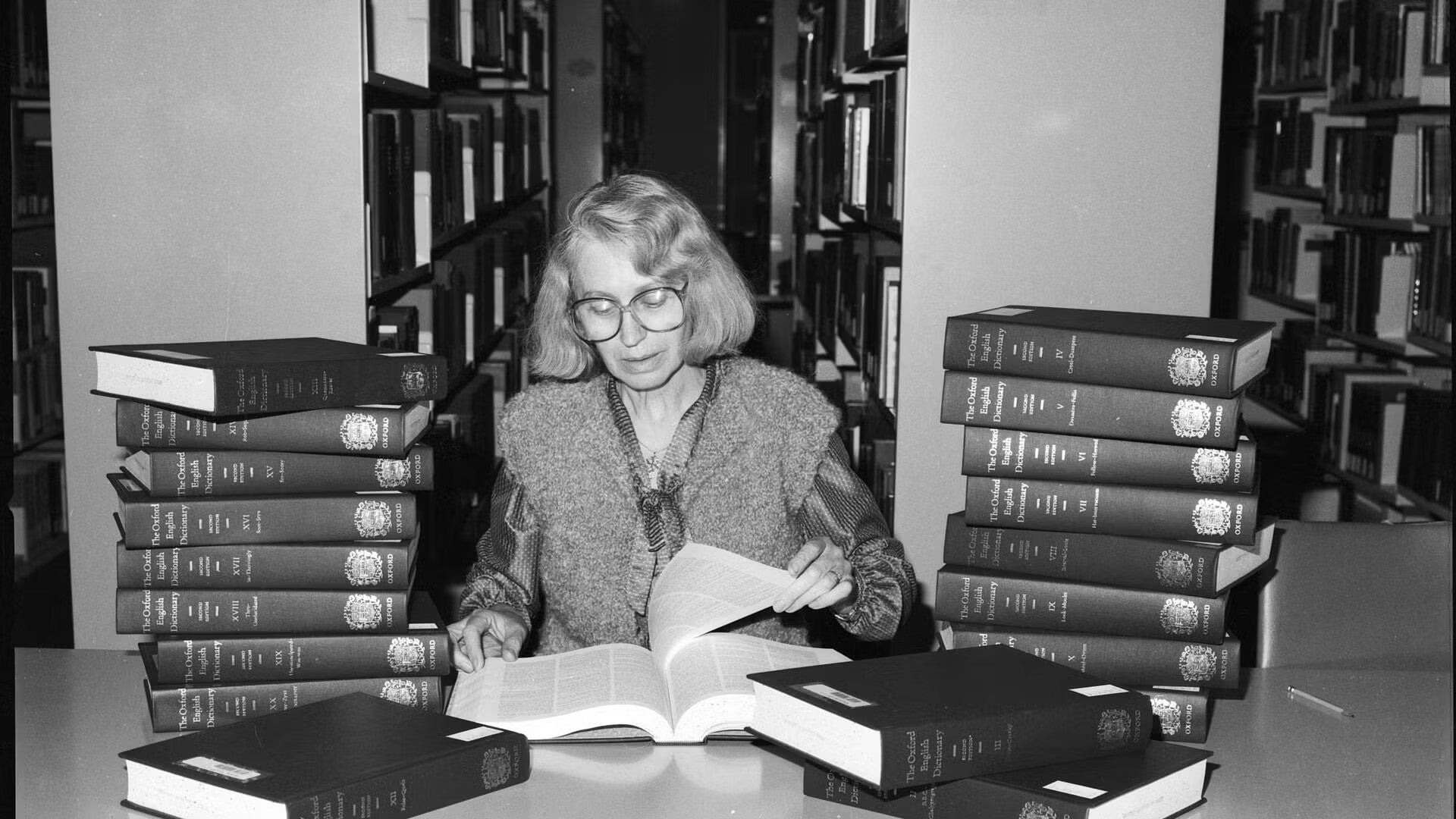 Librarian flipping through pages of a dictionary