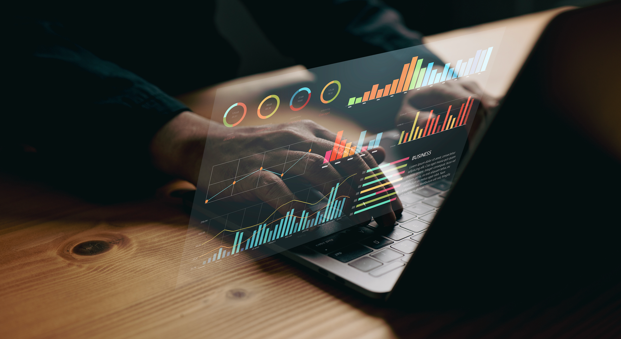 Laptop with reflection showing charts and graphs