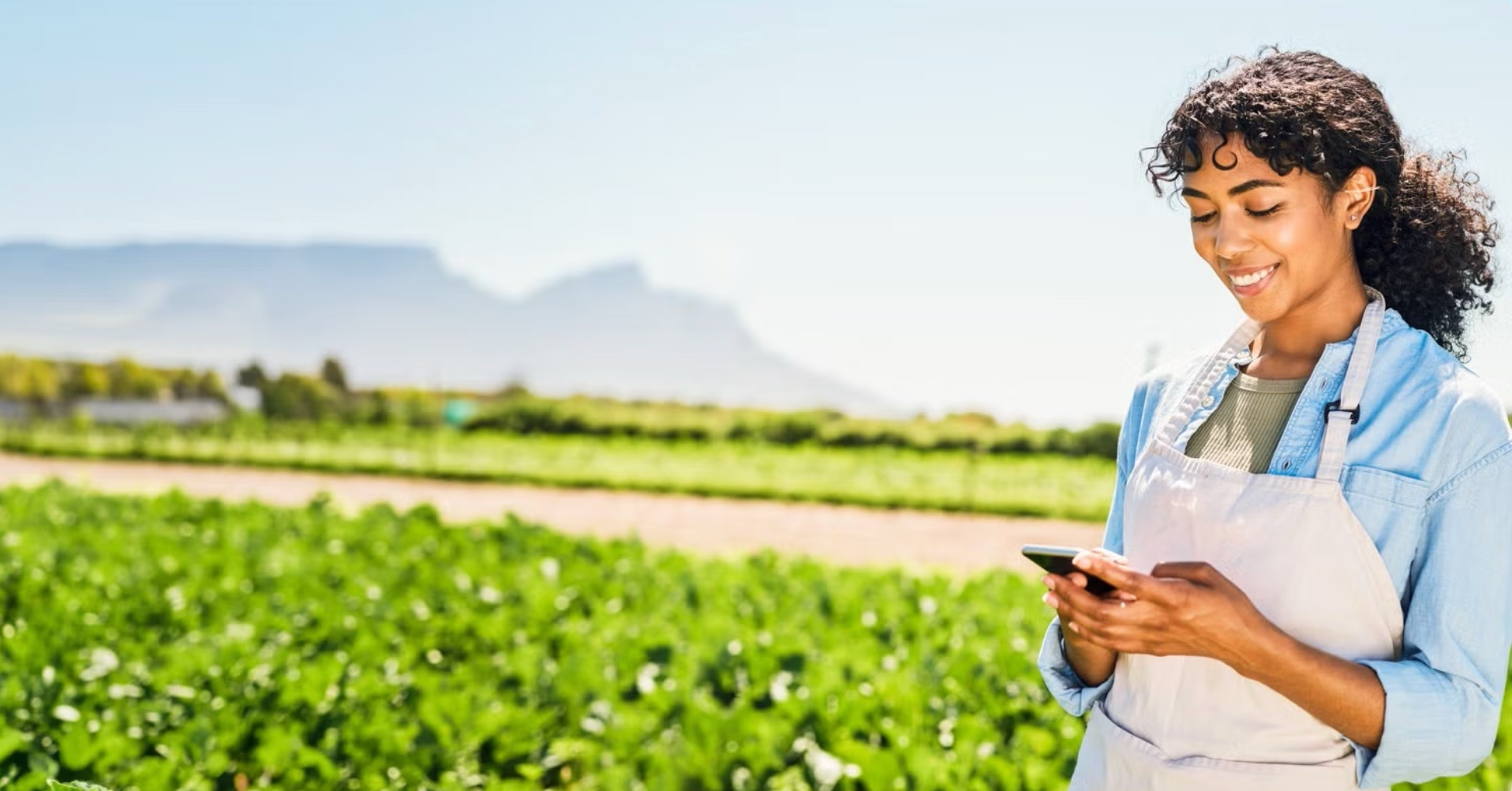 Woman on phone in farm field