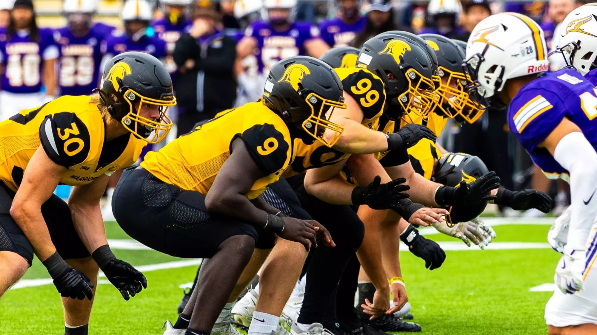 Warriors football players on field
