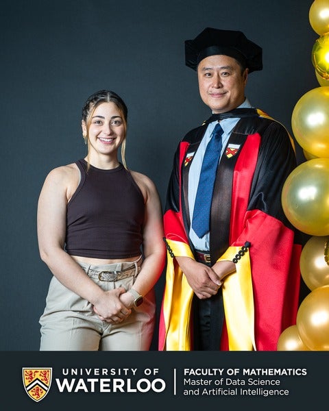 Silvana Shamuon and Professor Mu Zhu posing beside each other next to balloons