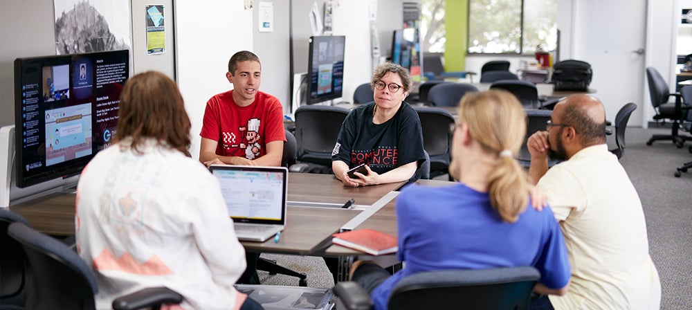 A group of students meeting with an advisor