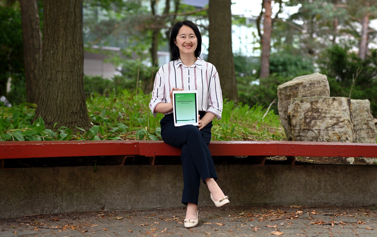 Professor Xi He with her book, Differential Privacy for Databases