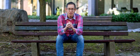 Jimmy Lin on bench in Waterloo's rock garden banner