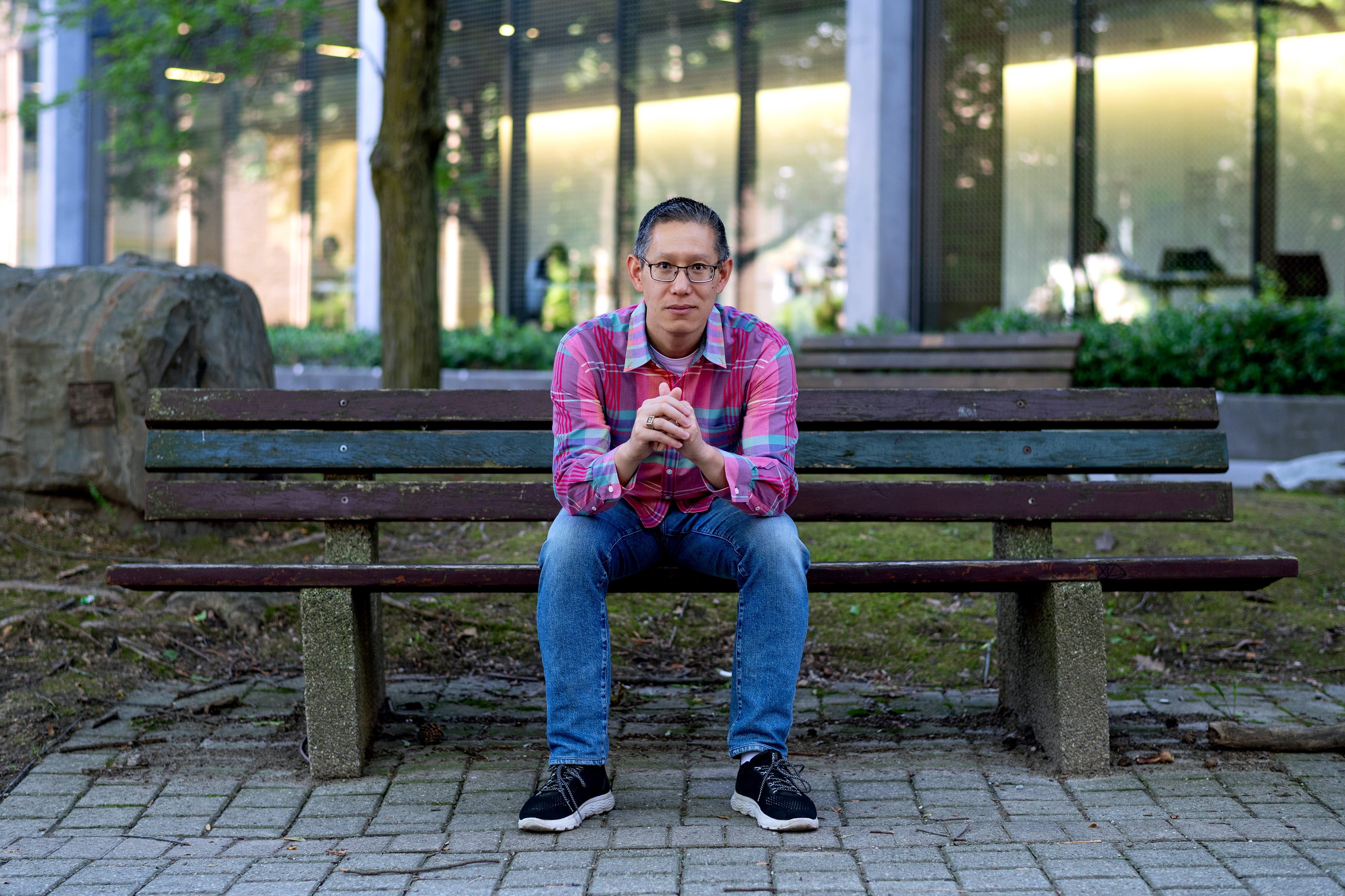 Jimmy Lin seated on a bench in Waterloo's rock garden
