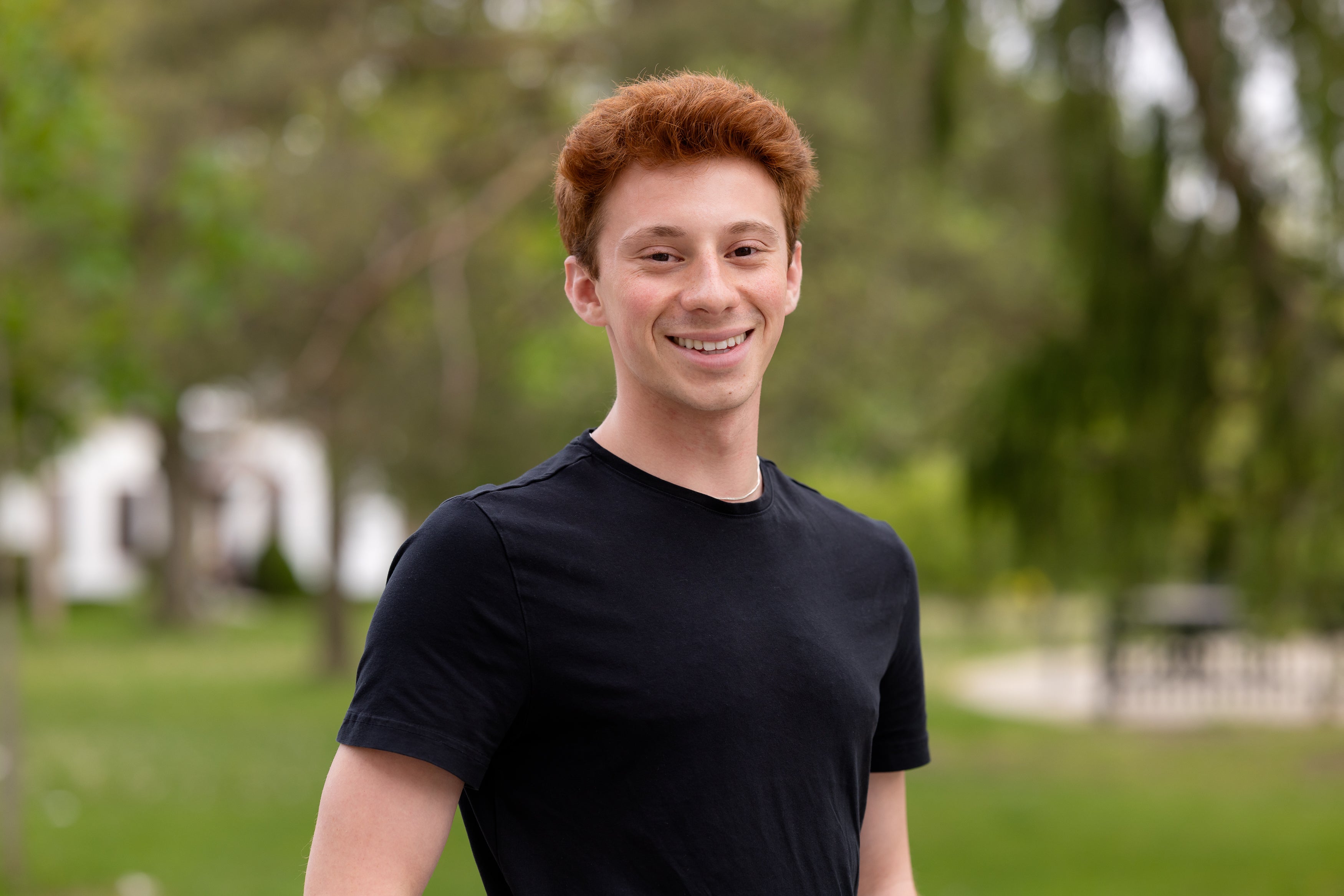 Daniel standing and smiling