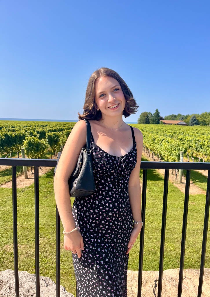 Claire standing and smiling