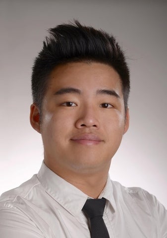Photo of Fergus Lam wearing white collared shirt with skinny black tie against a grey background
