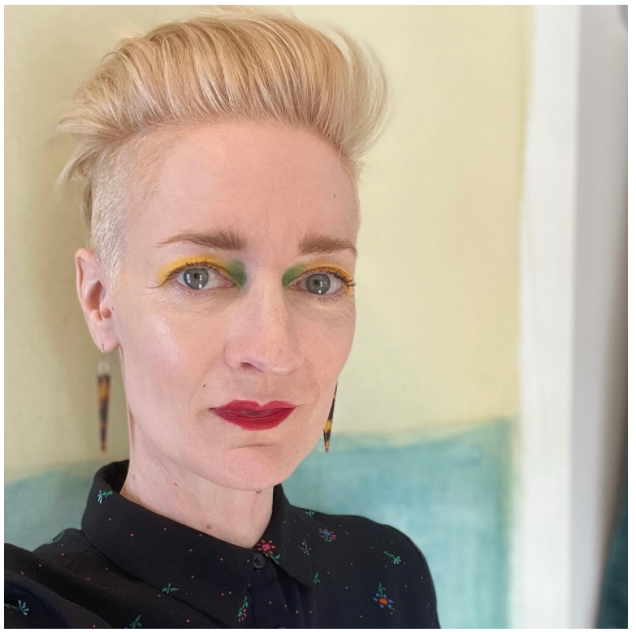 Aimée Morrison standing in front of a wall