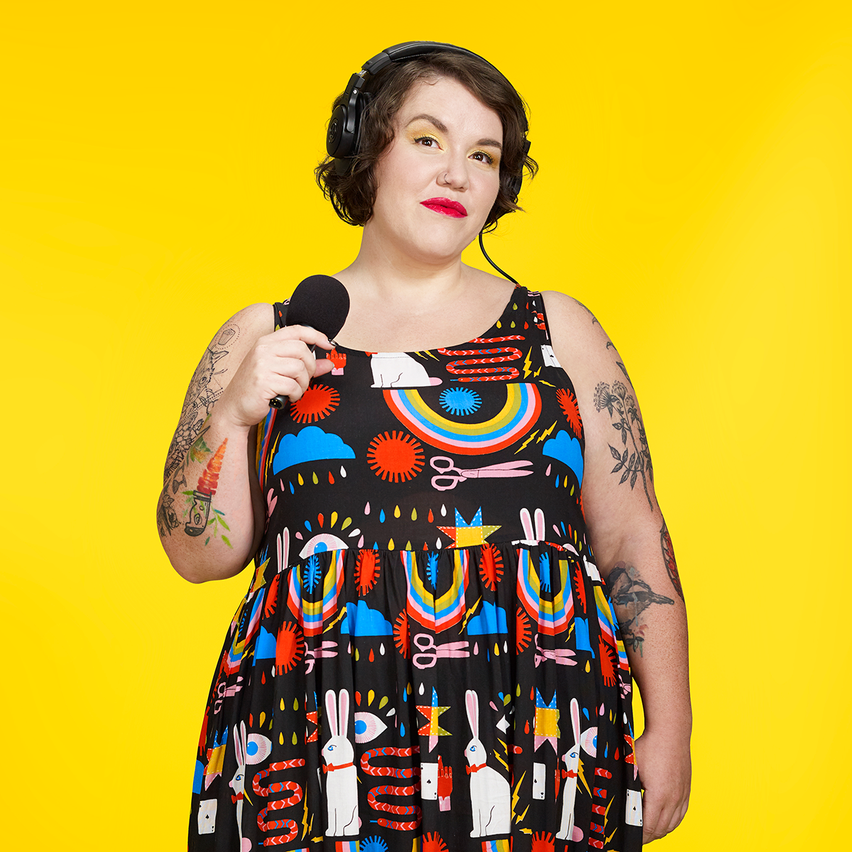 Hannah McGregor standing in front of a bright yellow background